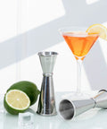 Double Head Cocktail Jigger For Bartending With Inside Measurements Japanese Grade 304 Stainless Steel Barware 1 Oz And 2 Oz shown with lime and cocktail