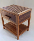 Handcrafted wooden side table with a geometric pattern top and drawer, showcasing wood textures and craftsmanship.