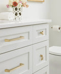 Elegant Blackrock Champagne Bronze Cabinet Pull With 6 5/16 Inch Hole Spacing on white drawers in bathroom setting.