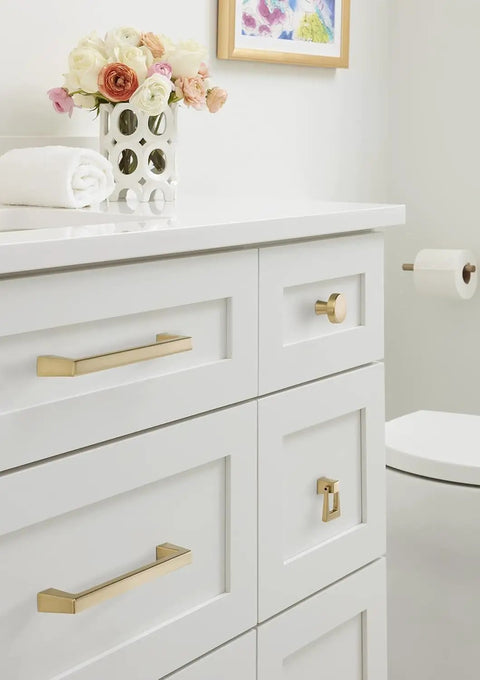 Elegant Blackrock Champagne Bronze Cabinet Pull With 6 5/16 Inch Hole Spacing on white drawers in bathroom setting.