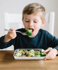 Child eating from Six Pack Stainless Steel Plates For Everyday Dining 9.2 Inch By 7 Inch Dimensions Food Grade Non Toxic Lead Free