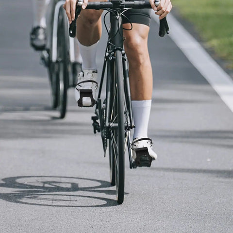 Cyclist using 2 Pack Toe Clip Pedals With Straps For Road And Commuter Bikes, Adjustable Foot Cages Fit Most Adult Bicycles