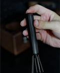 No Fuss WDT Needle Tool For Espresso Brewing Retractable Telescopic Coffee Ground Distributor held in hand for easy use.