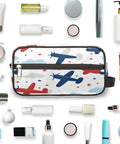 Adorable Airplane Travel Makeup Bag For Women And Men, Roomy Dopp Kit with airplane design, surrounded by toiletries.
