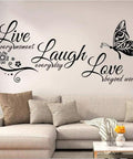 Live Every Moment Laugh Every Day Love Beyond Words Wall Decal Vinyl Quote above a beige sofa in living room decor
