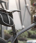 Under-Seat Bike Seat Bag, 3D Shell Saddle Pack with waterproof zipper, shock-resistant cushion, on a mountain bike.