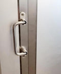 304 Stainless Steel Folding Pull Handle 90 Degree Door And Cabinet Pull Handle installed on door, 7 inch total length.