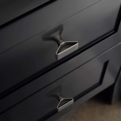 Six Pack Brushed Nickel Triangular Cabinet Knobs With Open Center Design for modern cabinets and drawers, shown installed on black drawer.