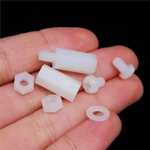 Three Sets Of M2 M2.5 M3 M4 Nylon Hex Spacer Columns Standoff Kit For PCBs And Motherboards With Screws Nuts And Washers Black 850 Pieces Ideal For Precise Component Spacing Alignment Quick Assembly And Durable DIY Electronics And Computer Builds, white nylon spacers in hand