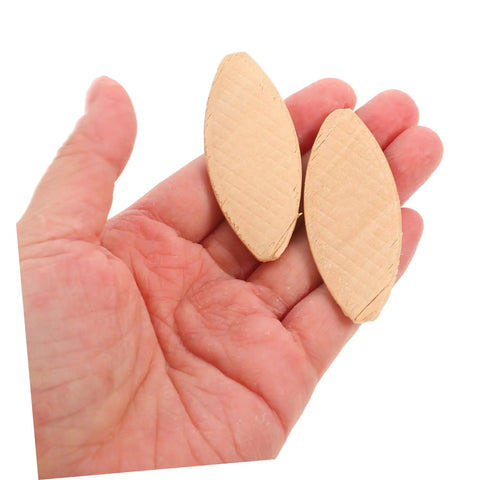 100 Piece Real Deal Hardwood Joiner Biscuits For Woodworking Board Jointing shown in hand, smooth edge and light yellow color.