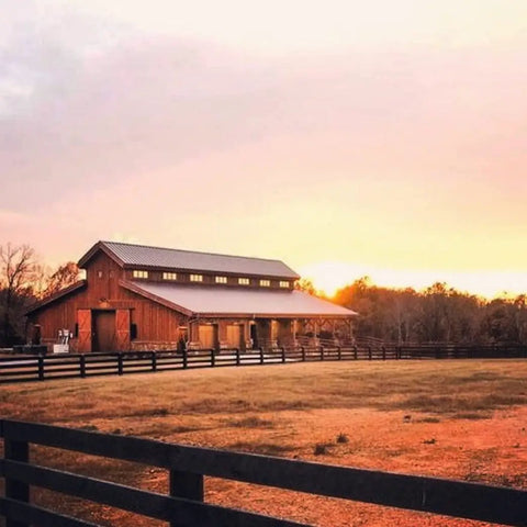 Buckwild Aging Wood Stain Drops Real Barnwood Charm On Any Deck Making Weathering A Hassle Free Experience Swirls Rich Grays And Browns In One Easy Swipe Locks In A Smooth Vintage Look Zero Toxic Buzz In A Trusty 5 Gallon Jug at a rustic barn during sunset.