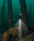 DL10R Dive Light 4500 Lumens Beast Mode Underwater Flashlight illuminating shipwreck, diver exploring with Type C rechargeable light