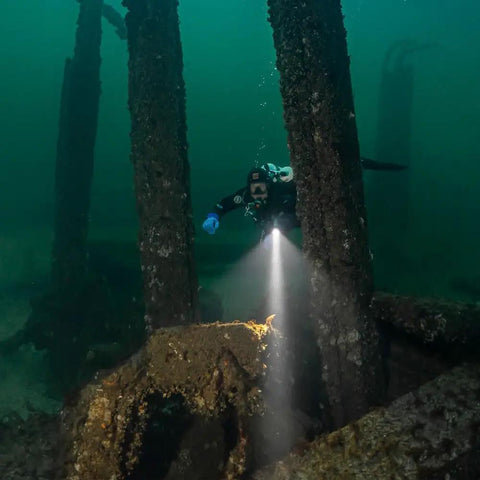 DL10R Dive Light 4500 Lumens Beast Mode Underwater Flashlight illuminating shipwreck, diver exploring with Type C rechargeable light