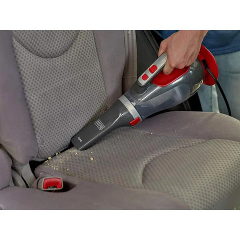 Dustbuster 12V Car Handheld Vacuum With Extra Long Nozzle And Crevice Tool Flexible Hose Sucks Up Crumbs From Between Seats Brush Attachment For Quick Cleanups Red Finish in use on car seat