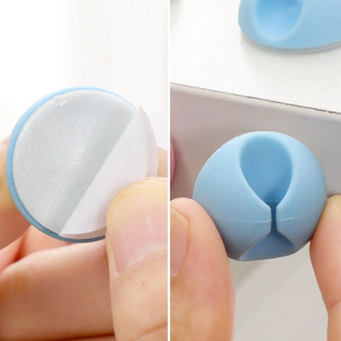 Close-up of 6 Pack Desk Cable Organizer Clips for Wire Management Adhesive Cord Holders in blue installed on desk edge.