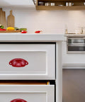 Red Cup Pulls Shell Style Cabinet Handles 6 Pack Iron With Spray Painted Finish installed on kitchen drawers.
