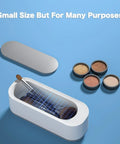 Ultrasonic Jewelry Cleaner Portable Pro Grade Household Cleaning Machine shown with makeup, lids off, on blue surface.
