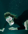 Heavy Duty Blue Safety Goggles With Anti Fog Ventilation And Side Shields To Keep Your Peepers Locked Up Tight Against Flying Debris Dust And Splashes On Any Rough Job Site worn underwater by a woman swimming.