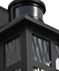 Built Different Matte Black Outdoor Wall Lights With Dusk To Dawn Motion Sensor And Water Glass Shade showing close-up of the geometric zinc body.