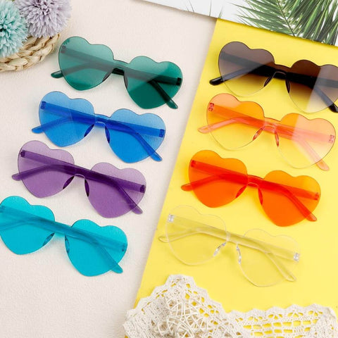 Heart Shaped Neon Green Sunglasses For Women And Men Unisex Rimless Glasses Lightweight 2-pack shown in different colors on yellow mat