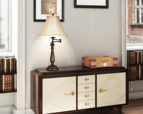 150W Three Way Swing Arm Table Lamp In Antique Rust Finish With Metal Construction Timeless Candelabra Style Retro Vibe For Home Office Lighting Perfect For Living Room Or Desk set on wooden cabinet in elegant room.