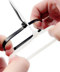 Close-up of hands fastening a white nylon cable tie with a black one, part of 100 Pcs Self Locking Nylon Cable Ties 60mm Long, 2.5mm Wide