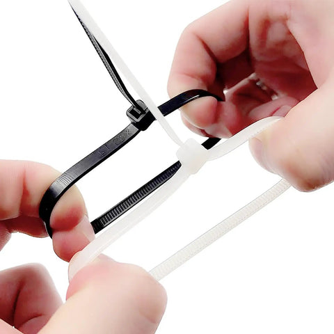 Close-up of hands fastening a white nylon cable tie with a black one, part of 100 Pcs Self Locking Nylon Cable Ties 60mm Long, 2.5mm Wide