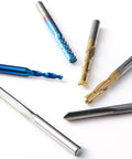 Genmitsu 50pcs tungsten carbide end mill set; scattered CNC router bits with blue, gold, and silver coatings.