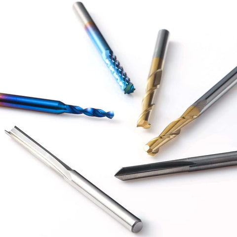 Genmitsu 50pcs tungsten carbide end mill set; scattered CNC router bits with blue, gold, and silver coatings.