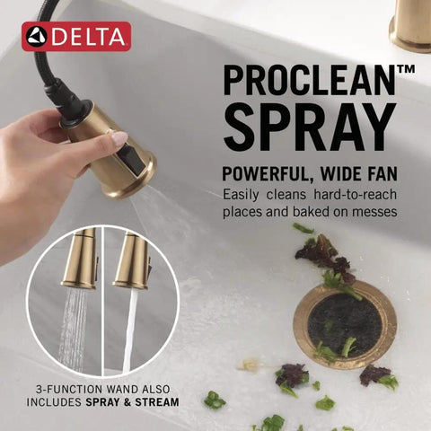 Modern Single Hole Kitchen Faucet With Slick Pull Down Sprayer Brushed Gold Finish showing ProClean spray wand in action over sink.