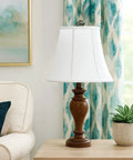 Modified Bell Lampshade In Linen White, 10.5 X 17 X 13.5 Inches on wooden lamp in a modern living room with blue decor