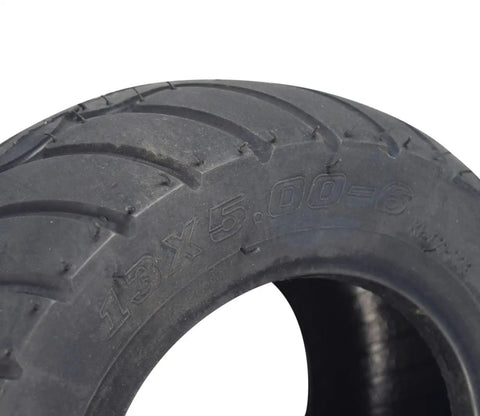 Close-up of 13x5.00-6 tubeless pneumatic go kart tire showing deep tread grip and durable rubber for front or rear wheels.