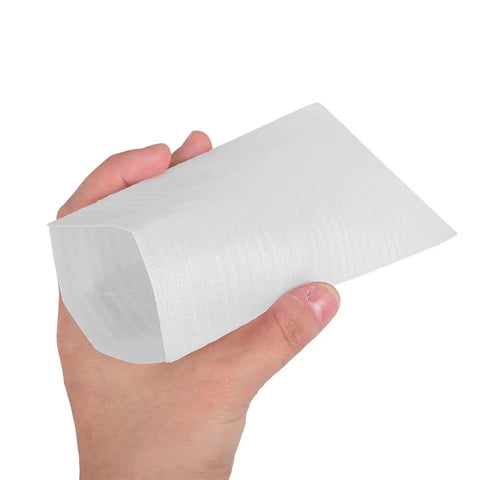 Close-up of a hand holding a white EPE packing bag sleeve from 100 Pack White EPE Packing Bags for Glassware Protection and Fragile Items.