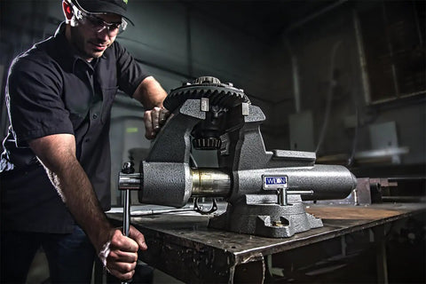 Mechanics Pro Bench Vise With Six And A Half Inch Jaw Width And Six Inch Jaw Opening For Precise Grips And Heavy Duty Metalworking clamped on workbench