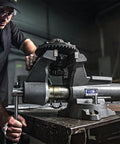 Heavy Duty Mechanics Bench Vise 8 Inch Jaw Width 8.5 Inch Opening Built Tough With Ductile Iron Base in use on a workbench.