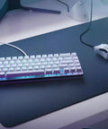 Solid Flex Compact Mechanical Gaming Keyboard With Heavy Aluminum Build Smooth Fox Switches Bright Per Key Rgb Full Nkro Support Uk Qwerty Mapping Sleek White Shell For Pro Setups on a gaming desk.