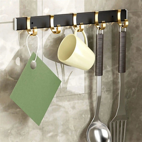 Sturdy Steel Wall Mounted Coat Rack Cool Fix For Your Hallway Or Living Room Easily Park Your Outerwear Totes And Keys To Keep Your Pad Spotless With Super Easy Everyday Storage hanging mugs and utensils on a sleek black and gold rack.