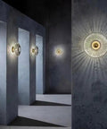 Awsinil Fluted Glass Wall Sconce, Modern Iron Round Decorative Wall Light illuminating a minimalist interior with shadows.