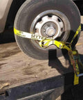 4 Pack Beefed Up Heavy Duty 2 Inch By 10 Foot Wheel Straps With Flat Hooks Lasso Style Tire Tie Downs securing a car tire