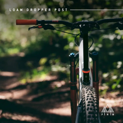 Loam Dropper Post Gen 2 Black Internal Routing MTB Seatpost With 25mm Adjustable Travel in forest trail setting.