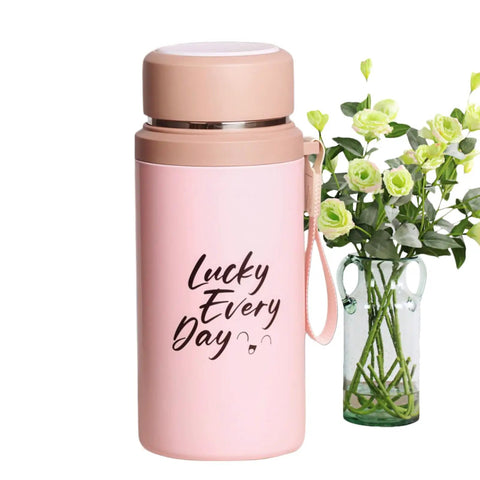 800ml Insulated Water Bottle With Tea Infuser, Leakproof Vacuum-Sealed Double-Wall Stainless Steel Flask next to green floral arrangement