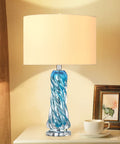 Dope Blue Glass Desk Lamp, 26 Inch Tall With Handcrafted Spiral Body, on a table beside a picture frame and coffee cup.
