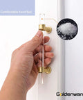 Hand holding a clear acrylic cabinet pull with matte gold finish, 30 Pack Six And A Quarter Inch Clear Acrylic Cabinet Pulls with Matte Gold Finish