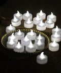 LED Tea Lights 24 Pack Battery Operated Flameless Candles With Realistic Flicker And Dope Long Battery Life arranged on dark background