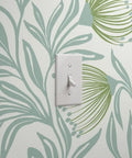 Badass Botanical Modern Vinyl Wallpaper With Smooth Leather Texture Heavy Duty Commercial Wallcovering Custom Printed Just For You For Offices Hotels And Major Event Spaces with light switch against leafy pattern.