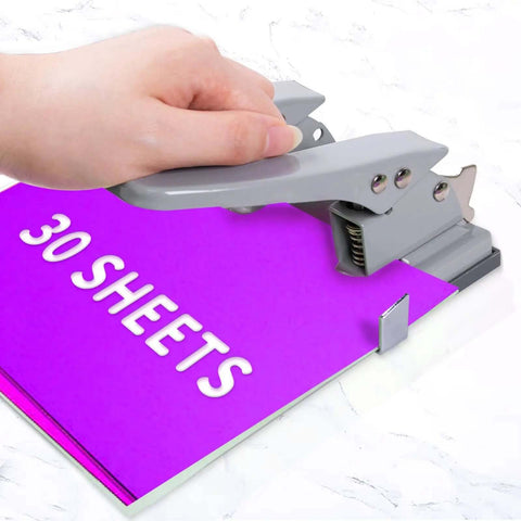 Hand using 2 Hole Punch for Paper, Adjustable Heavy Duty Metal Hole Puncher With Locking Handle, 30 Sheet Capacity, on purple paper