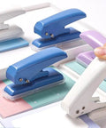 Assorted single hole punches including purple, showing different colors; Rugged Heavy Duty Single Hole Punch For Papers And Crafts 40 Sheets Capacity