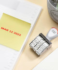 Slick 1.5 Inch Rubber Line Dater Stamp Featuring Quick Twist Dial Calendar Spanning Twelve Consecutive Years on office desk.