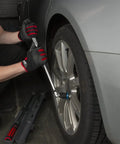 Using a Half Inch Drive Ratcheting Breaker Bar Adapter on a car wheel, converting a breaker bar into a reversible ratchet.