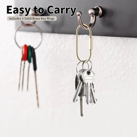 Premium Brass Key Ring With Screw Lock Carabiner Clip Gold Tone holding keys on a wall hook